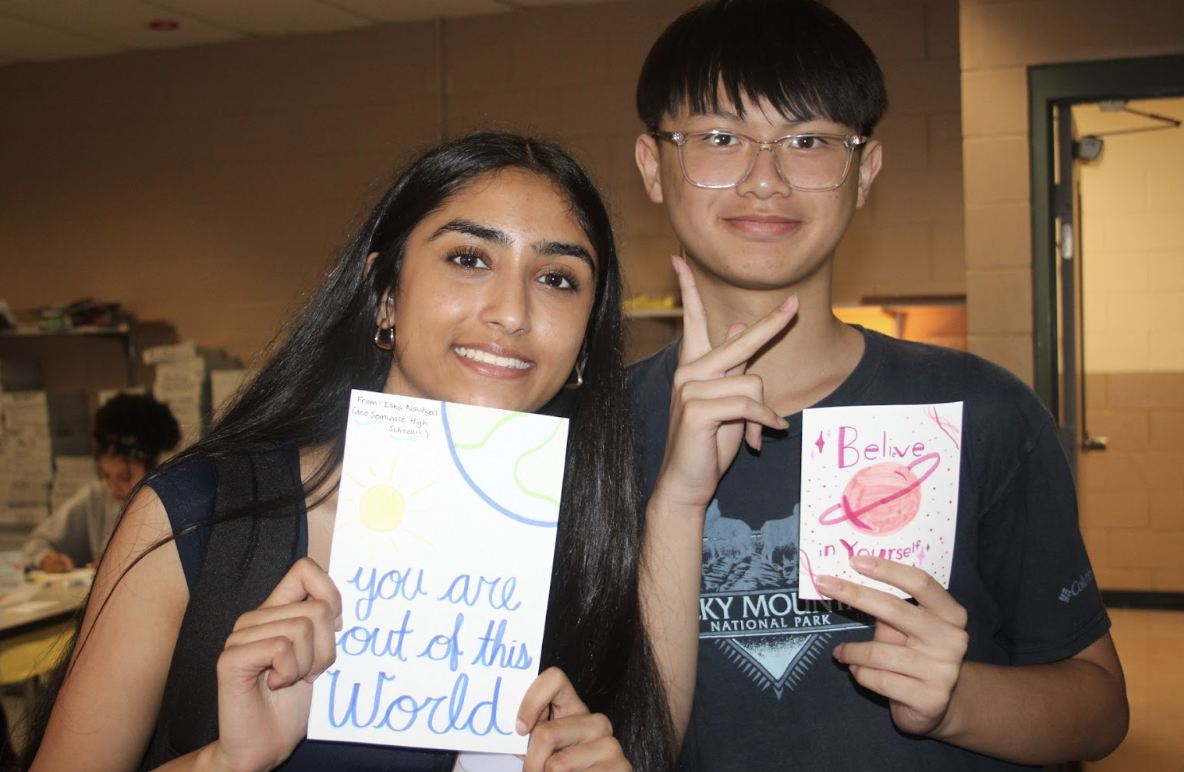 Co-Vice President Isha Naudiyal and member Trevin Le pictured with their space themed card.